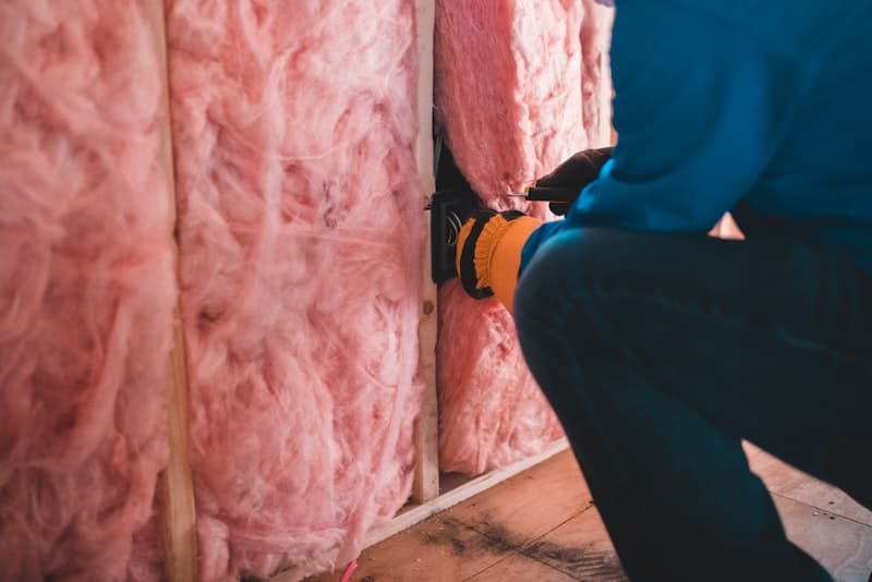 Loft insulation being installed in a UK home